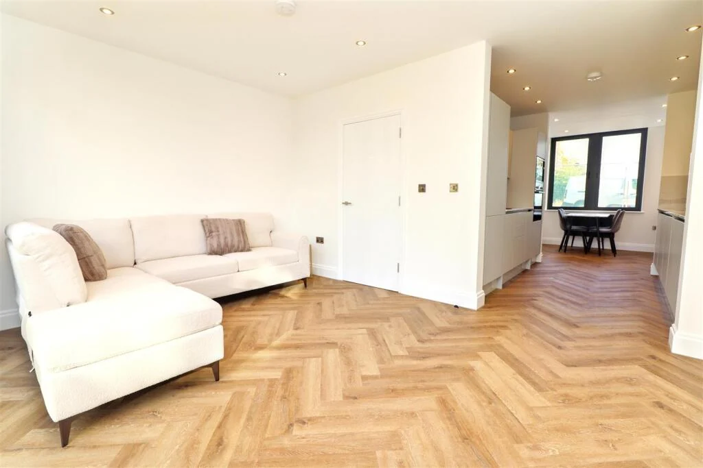 Living room with herringbone flooring at Harrington Place
