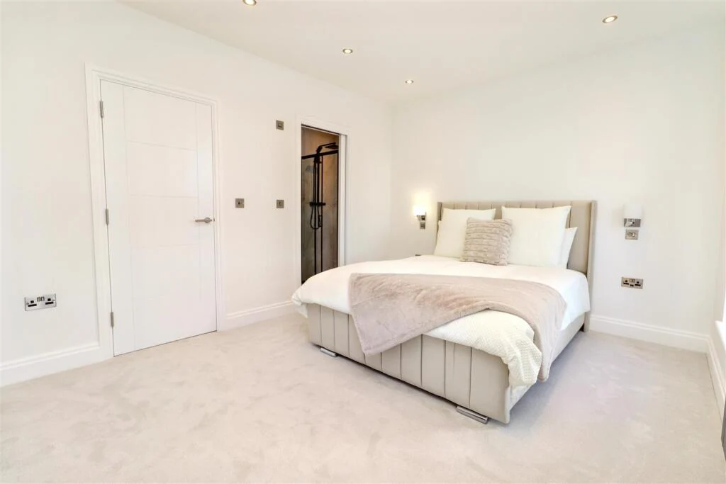 Bedroom with fitted storage and a soft neutral interior