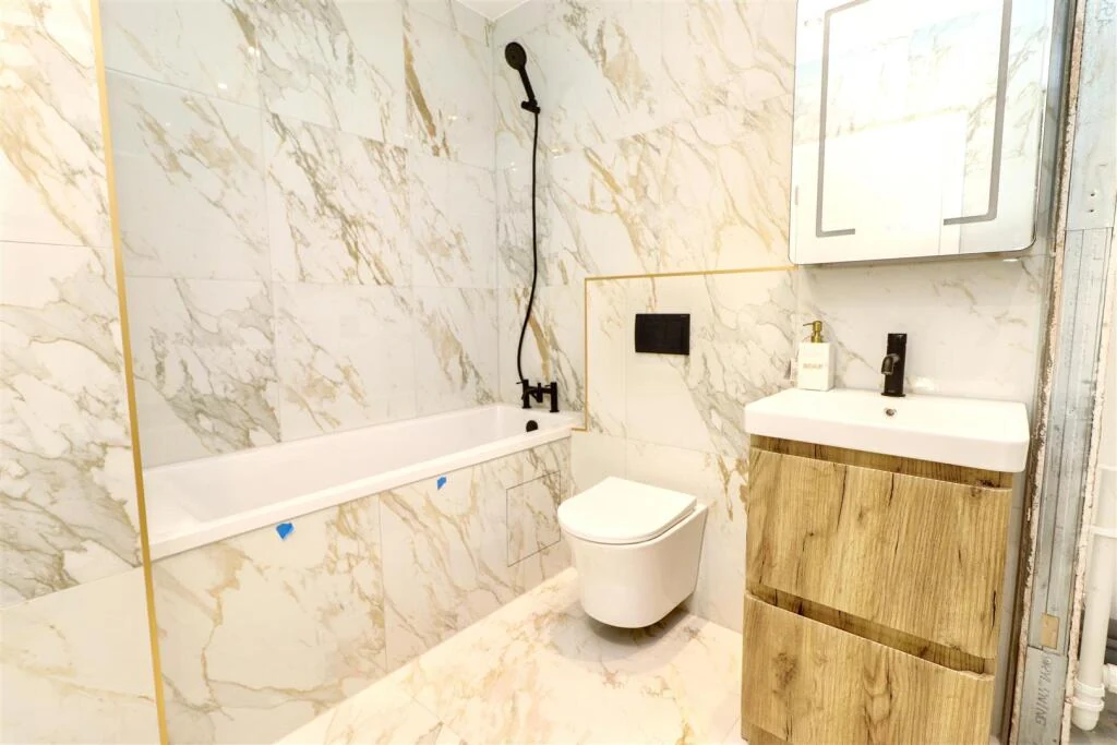 Bathroom with marble effect tiles and considered fittings